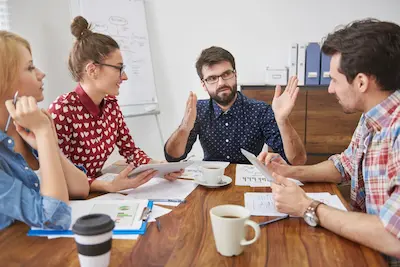 Creative team reviewing campaign ideas around a table